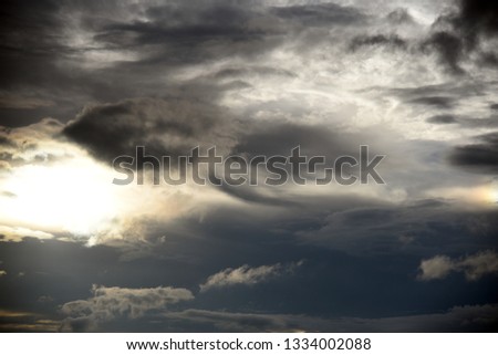 Hole of the Sky in the Dark Storm Clouds. Symbol of the struggle of good and evil. Light in the Dark and Dramatic Storm Clouds.