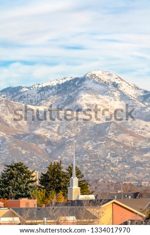 Rooftops against Wasatch Mountain and cloudy sky