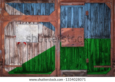 Close-up of an old warehouse gate with the national flag of Djibouti. The concept of export-import Djibouti, storage of goods and national delivery of goods. Flag in grunge style