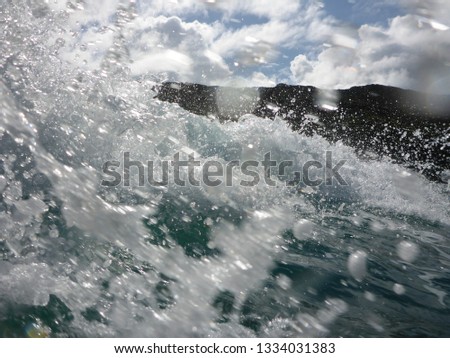 splashing water of a wave in the ocean at the coast of Great Barrier Island, New Zealand 