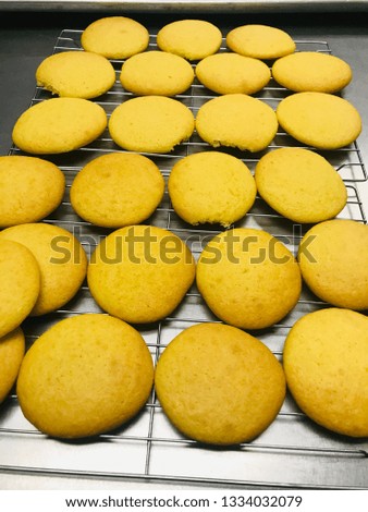 Warm Orange cookies on cookie rack for cooling