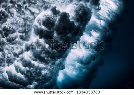 Powerful wave underwater with bubbles. Ocean in underwater