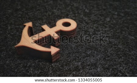 wooden anchor on black felt