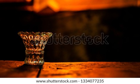 Evening party lighting with old wooden table and glass bowl