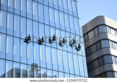 The team is cleaning the building's windows