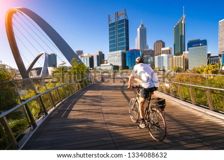 A man cycling on an elizabeth bridge in Perth city, western, Austrakia, this image can use for bike, sport, relax, healthy concept Royalty-Free Stock Photo #1334088632