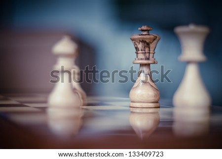 Olive made Chess King isolated with focus on a chess board