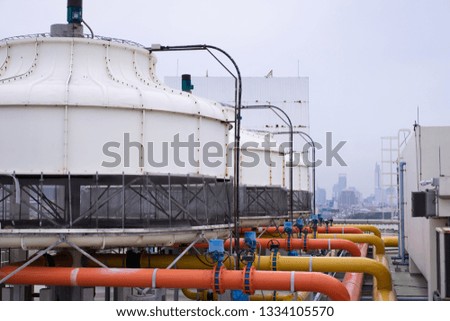 Tank to control extinguishing on the roof of the industrial factory in the heart of the city.