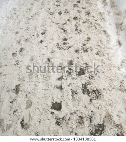 Footprints in the snow as an abstract background.