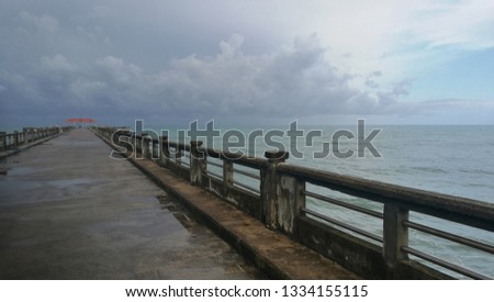 Pier with sea, sky and cloud at Natai beach, Phang-nga provience, Thailand. Quite, peaceful and beautiful place.