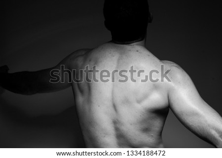 Photo of a handsome and sporty guy close-up in studio
