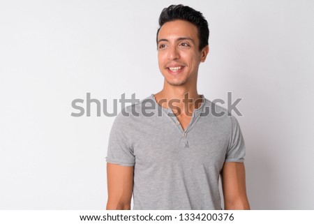 Portrait of happy Hispanic man thinking against white background