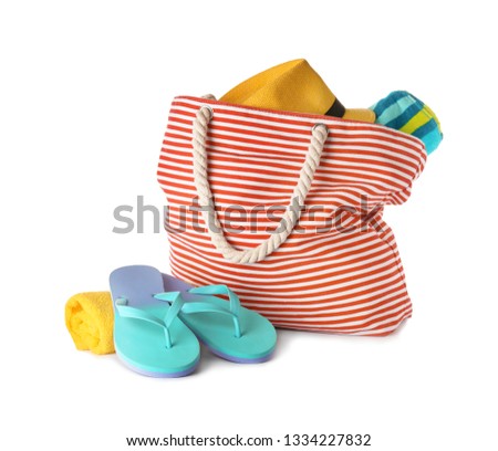 Composition with bag and beach accessories on white background Royalty-Free Stock Photo #1334227832