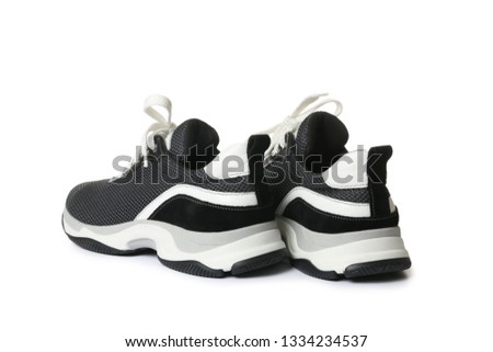 Pair of stylish modern training shoes on white background