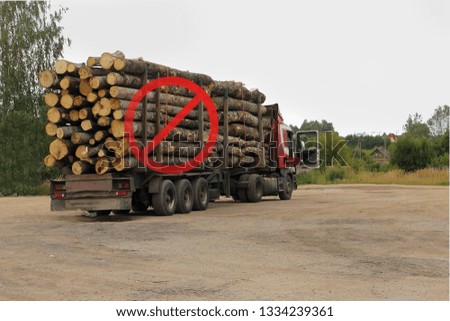 Forest industry.Trailer truck loaded with wooden beams with forbidden sign. Illegal logging concept