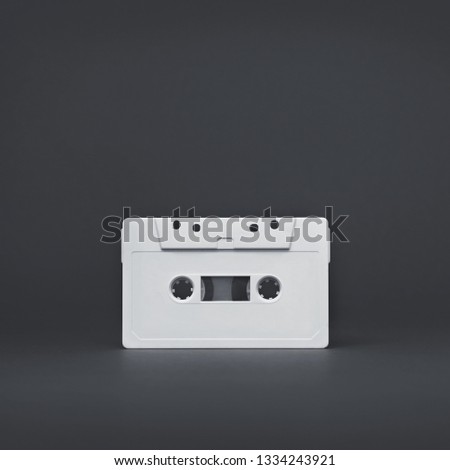 Audio cassette. Vintage white audio cassette tap on colored background. Old cassette tape audio isolated on white. Monochrome picture