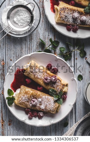 Delisious dessert with fresh fruit, mint and cheese filling inside crispy pancake