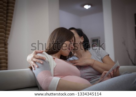 Mother kissing her pregnant