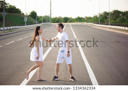 Couple in love - Beginning of a Love Story. A man and a girl dancing on the road.