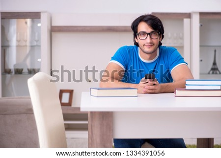 Young handsome student studying at home 