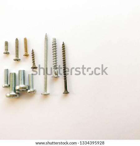 Screws with tools on a white background.