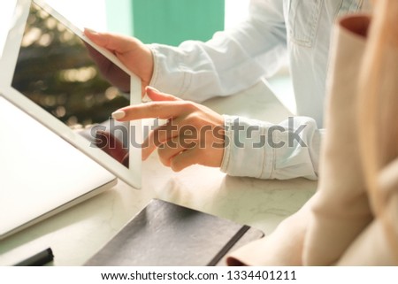 The girl touches the screen with her finger
