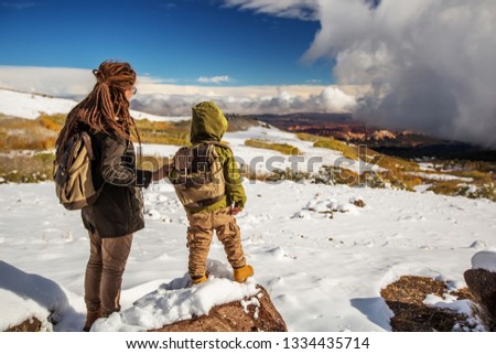 Mother with her little boy in snowy mountains