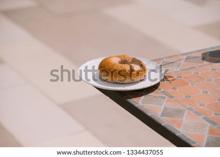 Breakfast Morning Sunny warm weather with donut on white plate on table background. Good mood Horizontal view 