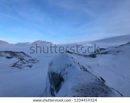 View over the mountains, valleys, and glaciers on a snowmobile trip to the eastcoast of Spitsbergen Svalbard