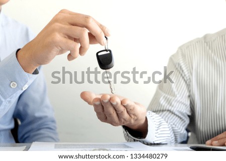 Salesman send key to customer after good deal agreement, Concept of car insurance, rental, sales.
