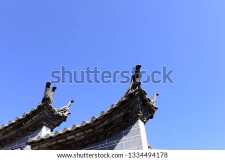 The corner of the ancient building against the blue sky