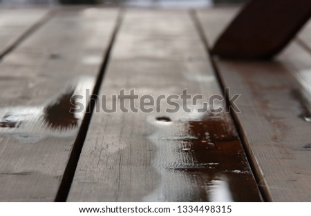 Puddle of water on the wooden veranda floor