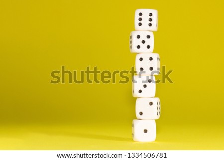 White gaming dices on yellow background, stack. victory chance, lucky. Flat lay, place for text. Top view. Close-up. Concept gamble. Royalty-Free Stock Photo #1334506781