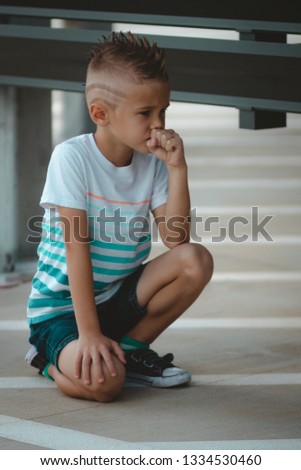 Young boy model with mohawk posing to photographer for fun