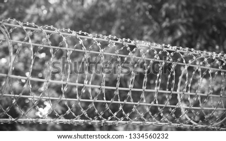 Round shape metallic protection fence   black and white photo