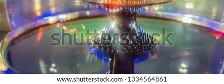 ferromagnetic fluid magnetized by a magnet in a science museum BANNER, LONG FORMAT Royalty-Free Stock Photo #1334564861