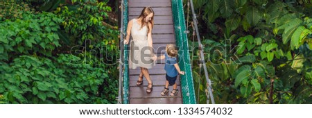 Mother and son at the Suspension bridge in Kuala Lumpur, Malaysia BANNER, LONG FORMAT