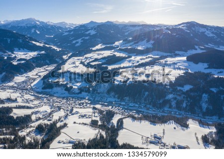 Beautiful aerial drone panorama of mountain valley, road and villages in cold winter day