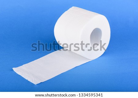 Roll of toilet paper isolated on blue background. Copy space