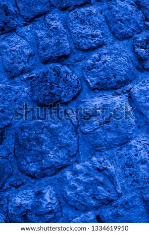 Blue texture of the wall of an ancient castle at an angle of 10 to 45 degrees