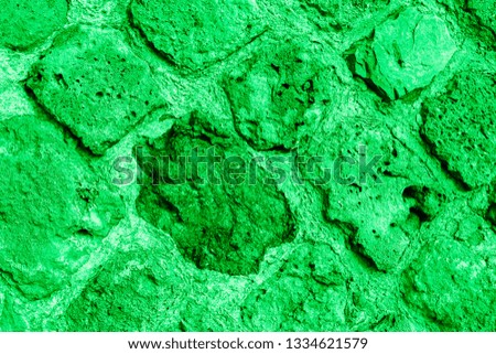 Green texture of the wall of an ancient castle at an angle of 10 to 45 degrees