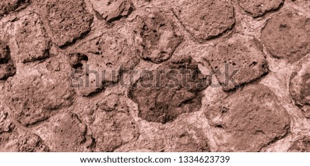 Background and texture of the wall of an ancient castle at an angle of 10 to 45 degrees