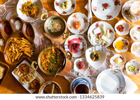 Top view of traditional Turkish breakfast with lots of varieties including different jams, cheese and fries. Royalty-Free Stock Photo #1334625839