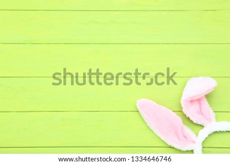 Easter rabbit ears on green wooden table