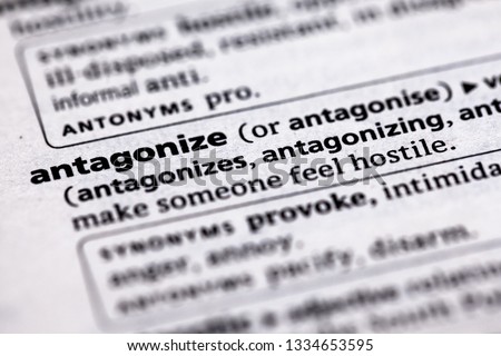 Blurred close up to the partial dictionary definition of Antagonize