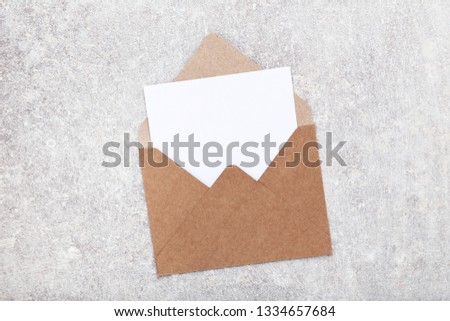 Blank paper with envelope on grey background