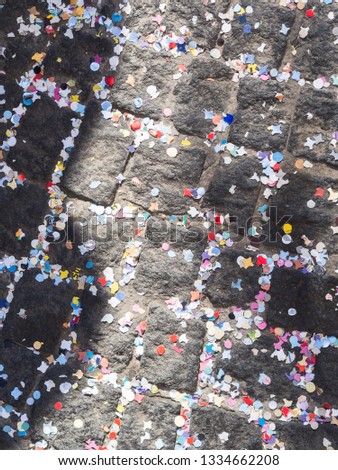 Pavement covered with colorful confetti. Holiday celebration
