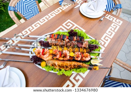 dish with grilled meat and seafood on the table