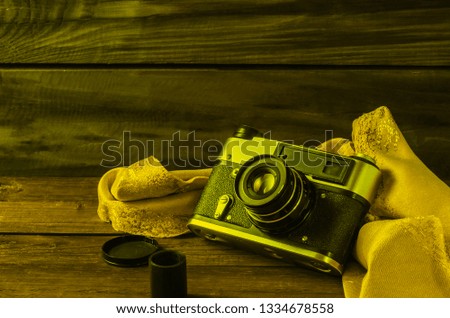 Still life photographic film and film camera on different backgrounds.