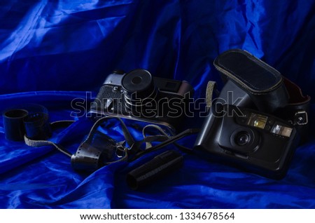 Still life photographic film and film camera on different backgrounds.